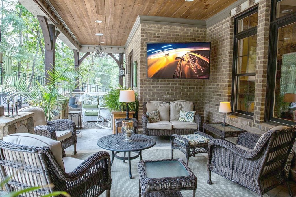 A beautiful outdoor space with comfortable furniture and a big screen TV.