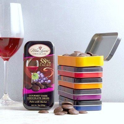 A glass of wine is pictured and next to it, wine infused and flavoured Wine Lovers Chocolate.