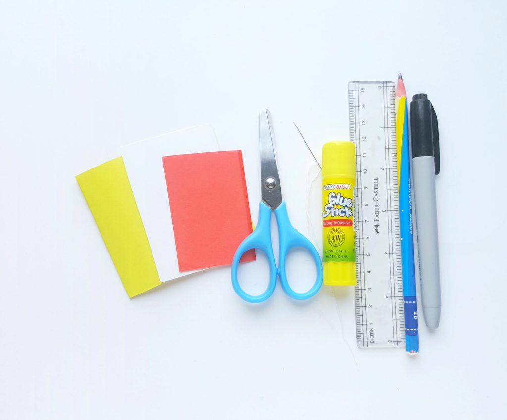 Supplies Needed to Make Pokémon Notebooks: coloured paper, scissors, needle and thread, glue stick, ruler, pencil, and marker. 