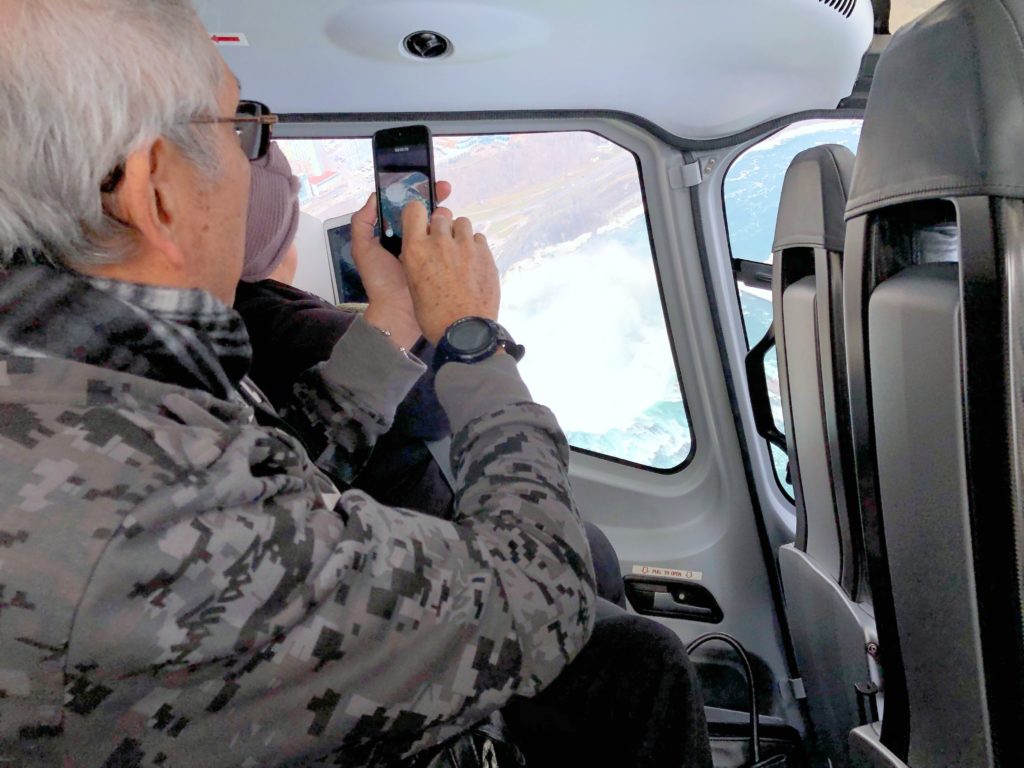 Frank Sr. is shown taking a picture of the Niagara Falls with his phone. 