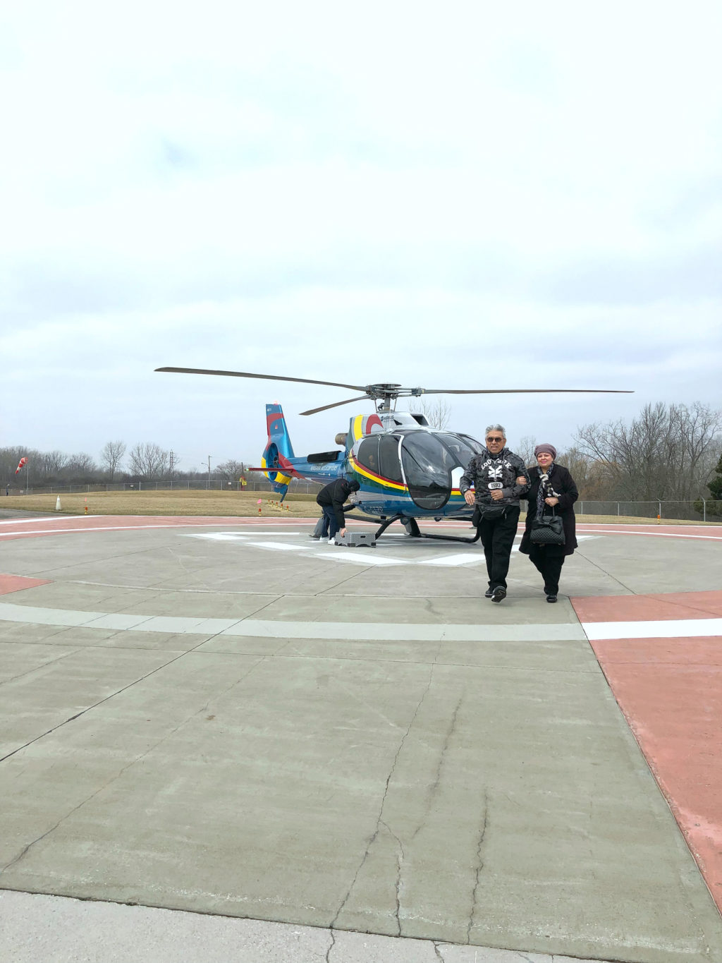 An older couple step off a helicopter at the Niagara Falls Helicopter Tour.