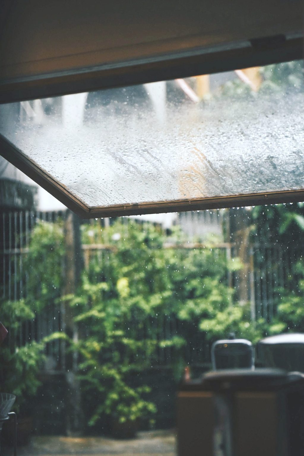 A backyard porch shows rain falling and makes you think of ways to prepare for storm season.