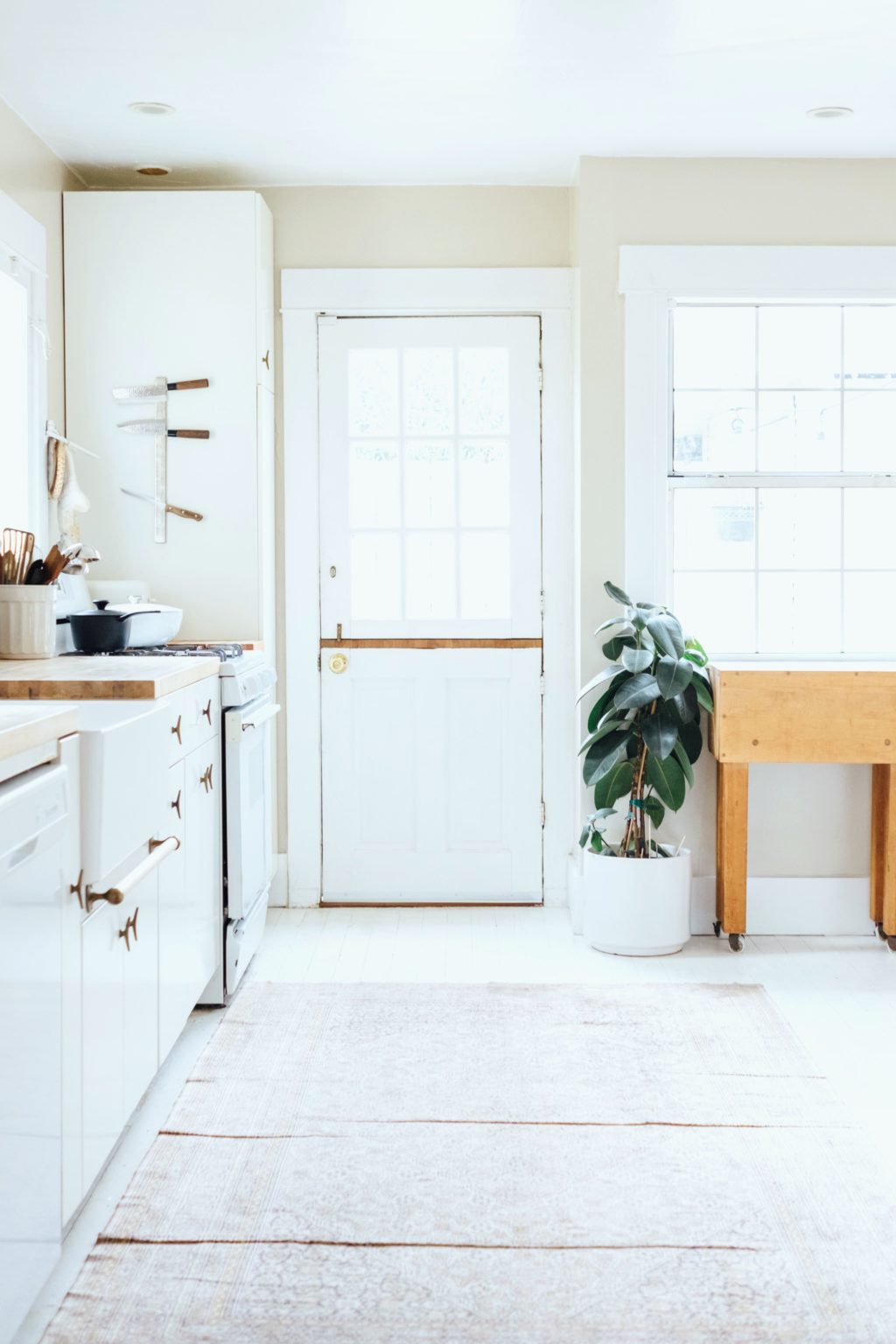 Kitchen is shown with greenery and heirlooms displayed. Kitchen decor is especially important to add extra touches to your home. Whether it's greenery or your finest china set, they add a personal touch. 