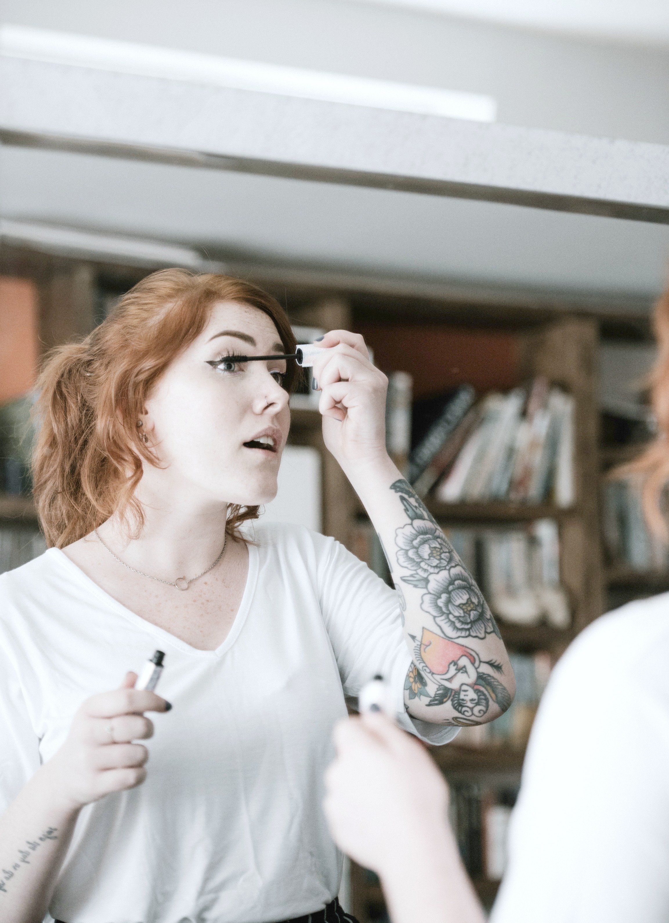 Woman puts on mascara in a mirror. When you look good and feel good, inside and out, it makes you confident. Here are some tips to help you improve your appearance & boost your self-esteem. #tips