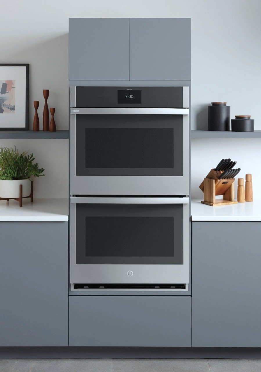 A double oven in a gorgeous white and grey kitchen. 