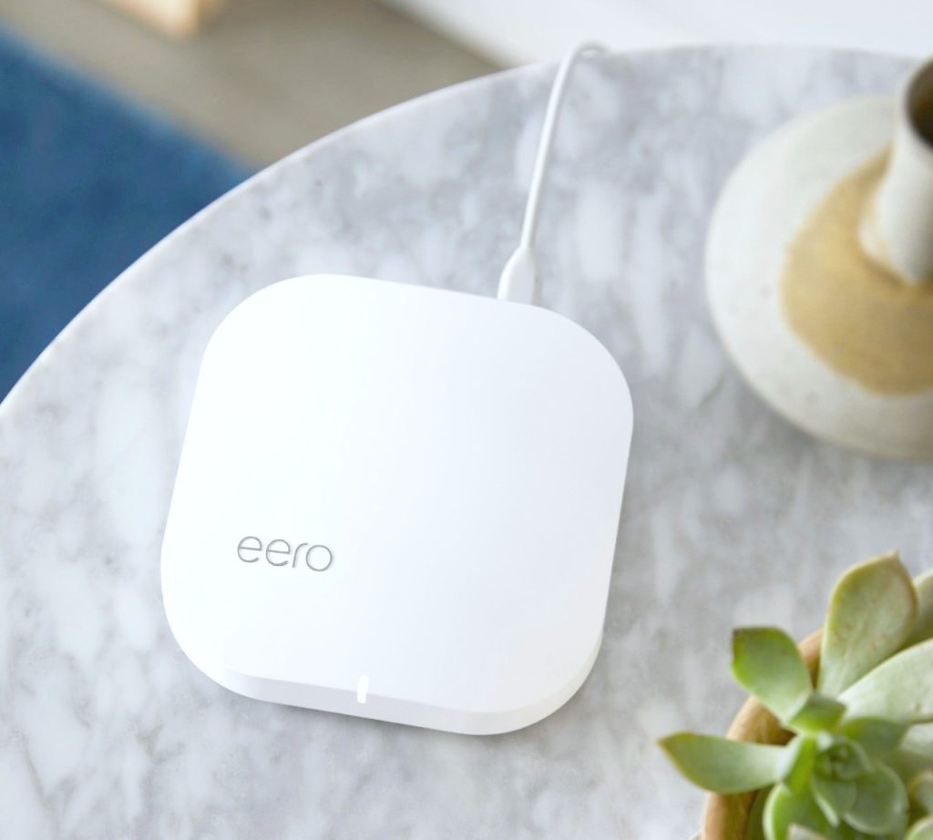 A flat lay of an Eero on a grey marble table. 