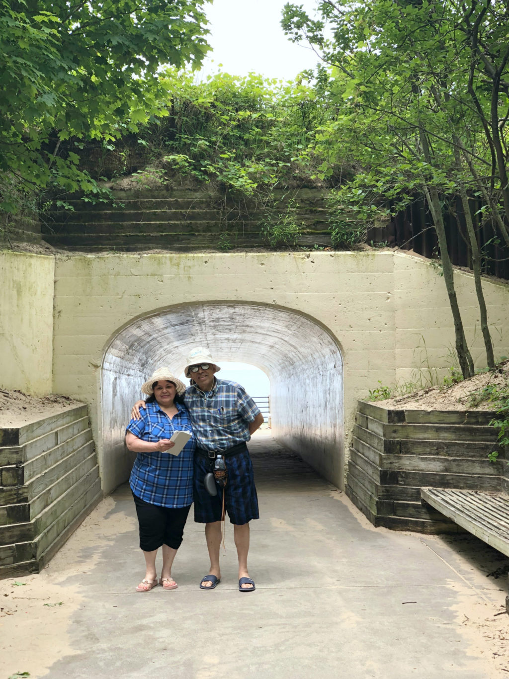 Nancy's parents, Milagro and Francisco pose in front of the tunnel at Tunnel Beach in Holland, MI.