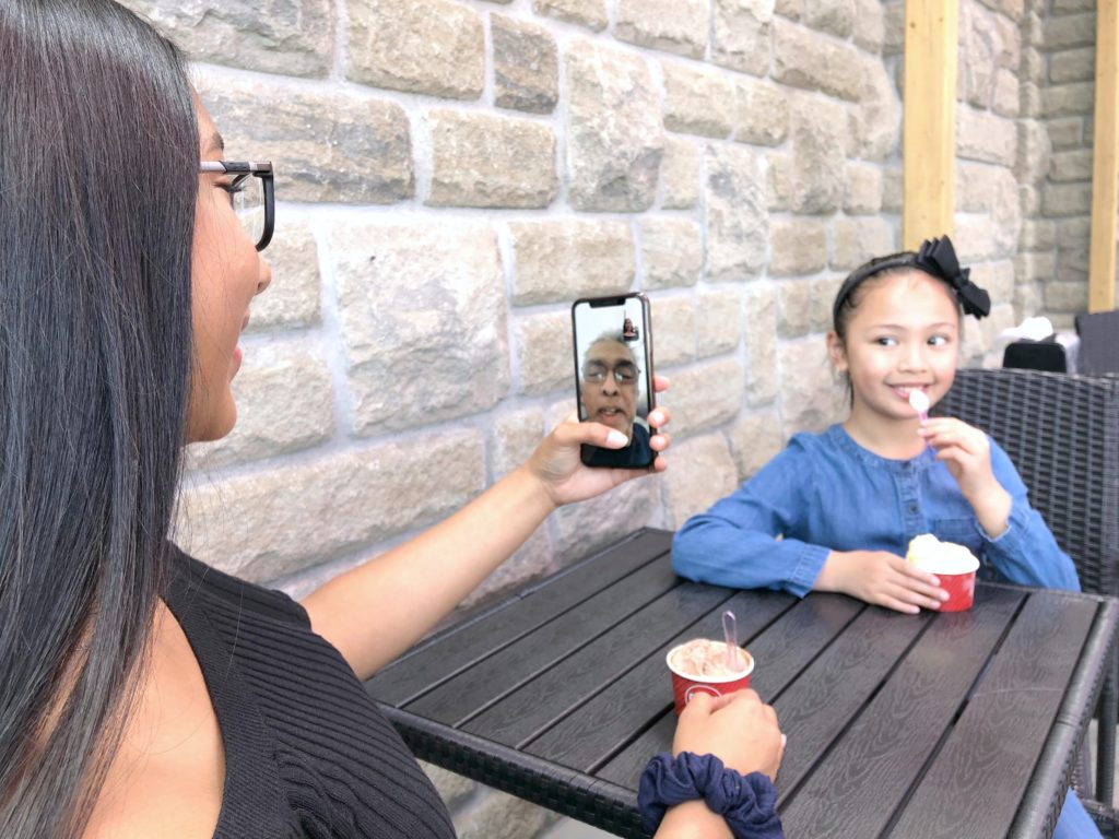 Gabby calls her Grandpa on FaceTime and Mimi eats gelato across the table from her,