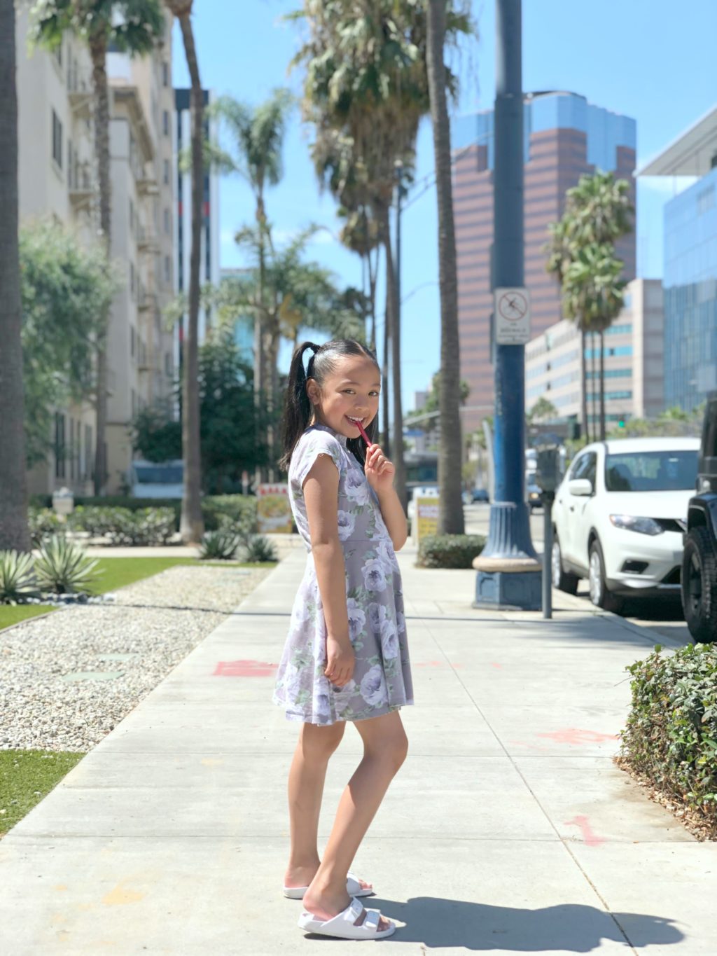 Mimi eats licorice and stands on Ocean Drive in Long Beach.