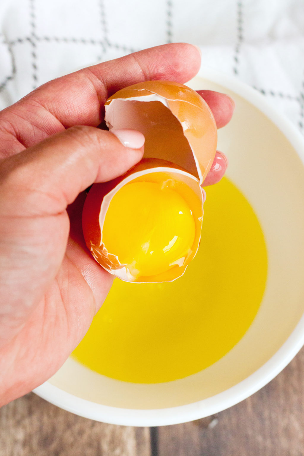 A woman separates the egg yolk and egg whites. 