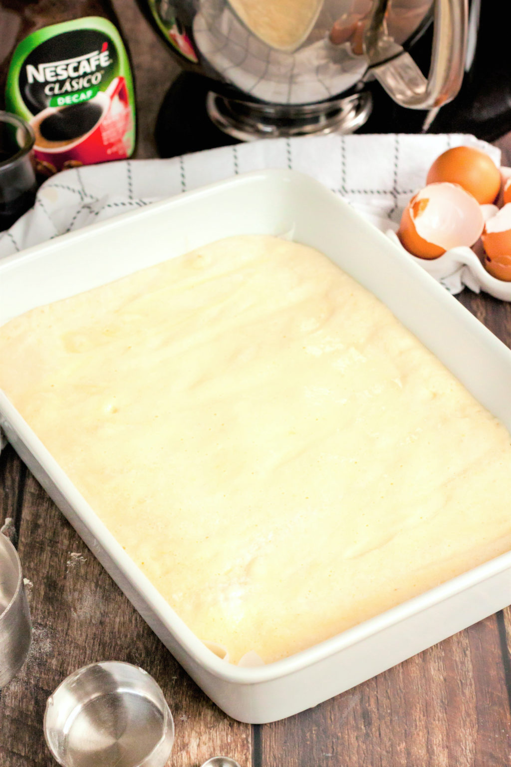 A pan is filled with Coffee Tres Leches Cake mixture.