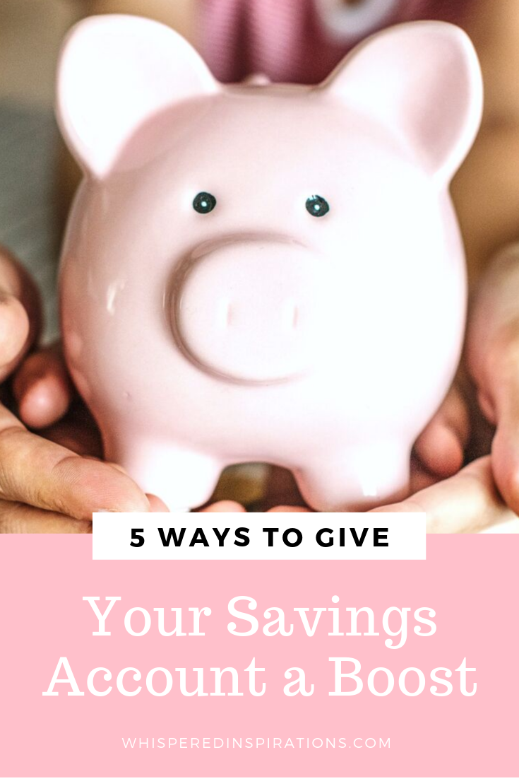 A couple and their daughter hold a piggy bank together. Coins surround the piggy bank. Below, a banner reads, "5 ways to give your savings account a boost."