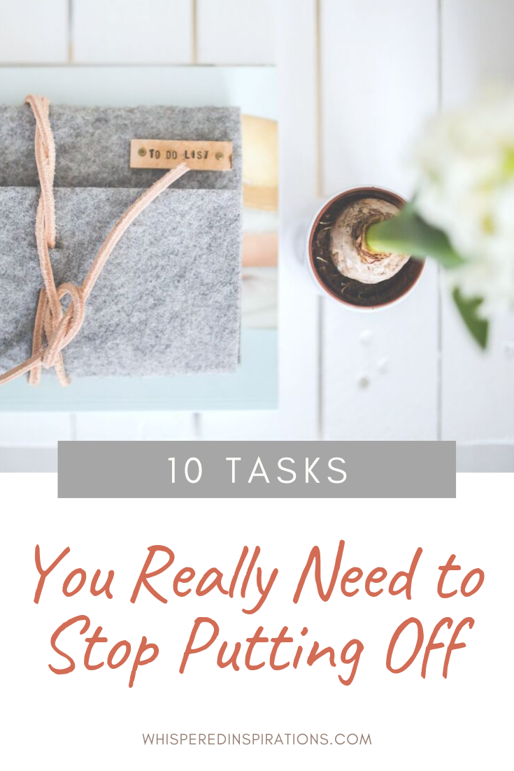 Grey agenda that says "to-do" list on a white wood table, a flower is seen from a bird's eye view. A banner reads, "10 tasks you really need to stop putting off."