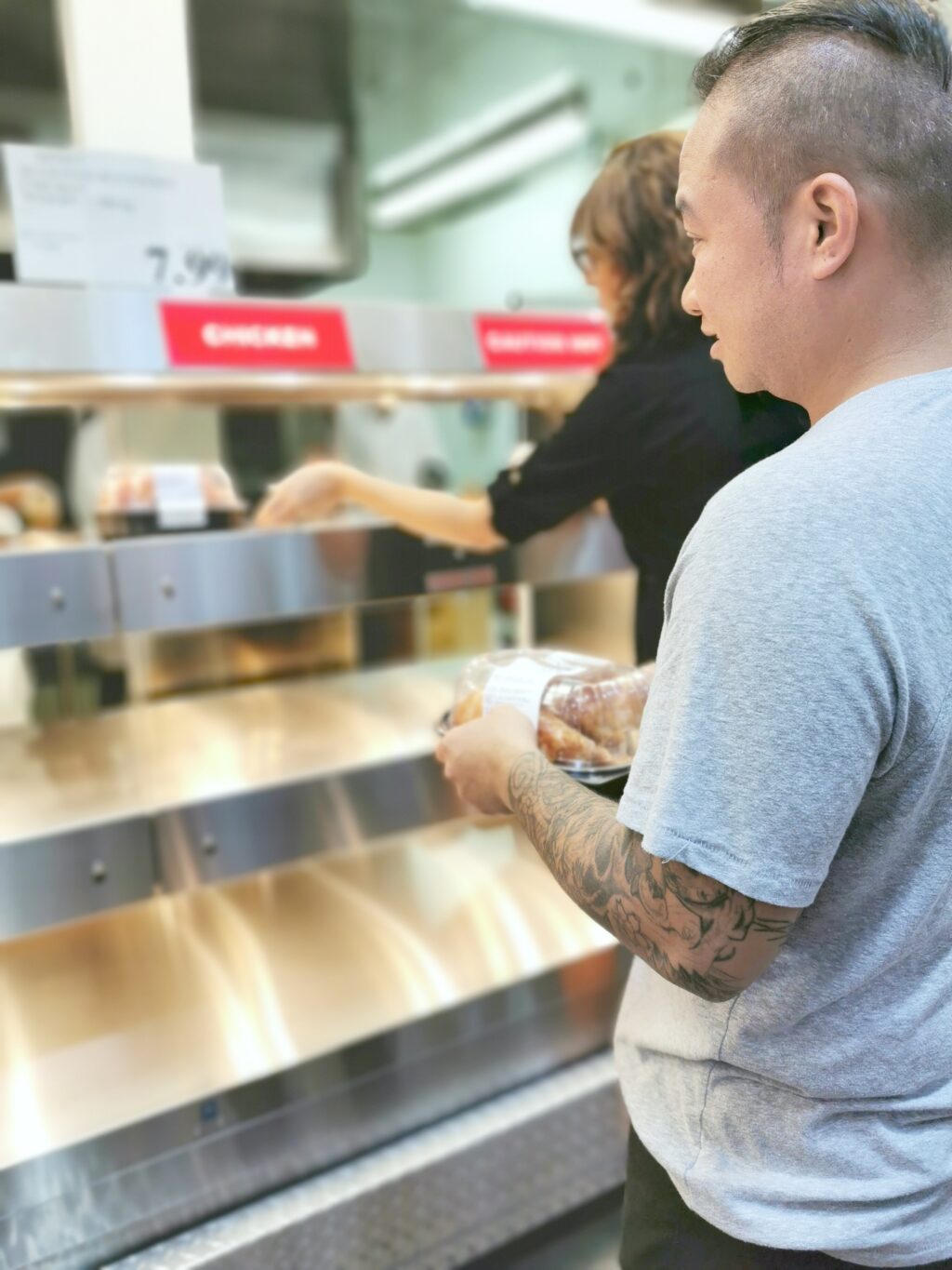 Darasak waits for a rotisserie chicken at Costco. 