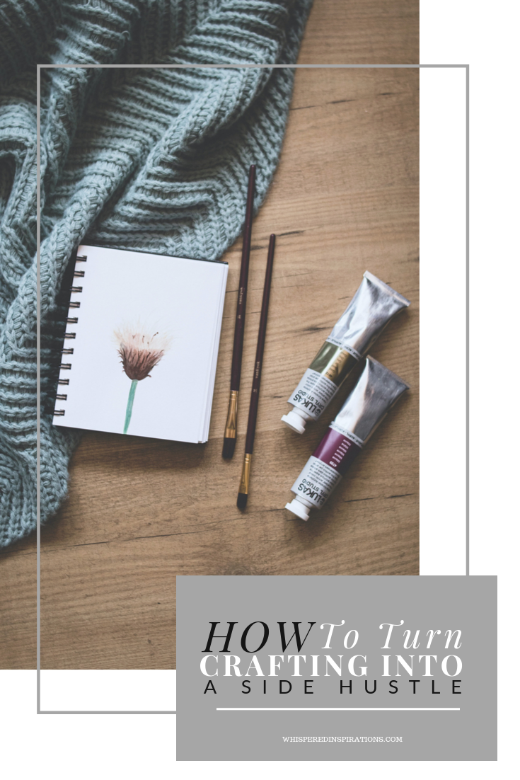 Throw blanket, notebook, and water colours on a wooden background. A banner that reads, "how to turn crafting into a side hustle."