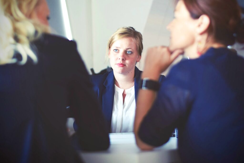 Woman looks at two people disappointed. They sit at a desk and look at each other. Woman is across from the other two women. When you’re choosing a professional service, there’s always a risk something can go wrong. Here is how to know when you've been let down by a service. #tips