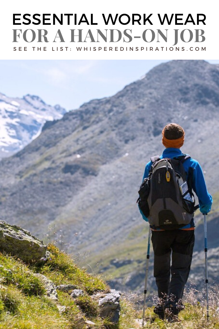 Man is hiking, he has hiking gear on and walking sticks. The mountains are seen in front of him. They are massive. A banner reads, "Essential Workwear for a hand-on job."