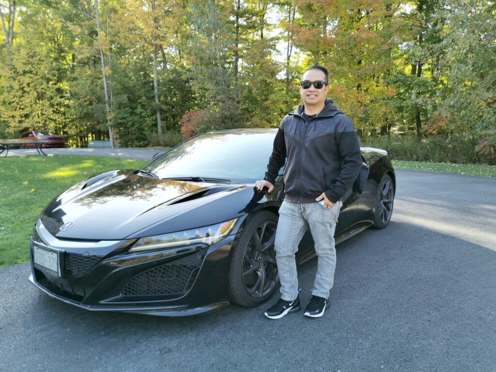 Darasak stands in front of an Acura NSX. This is for a super car test drive experience with Breakaway Experiences. 