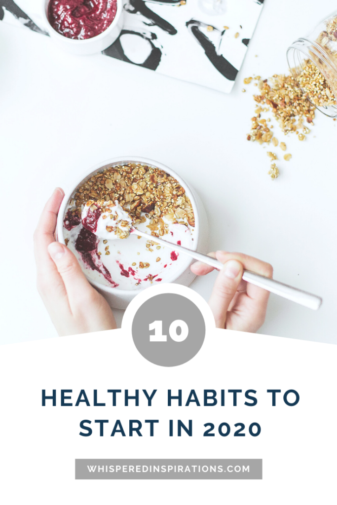 Woman eats yogurt parfait with granola and fruits, only her hands are shown and she is holding a spoon. A banner below it reads, "10 healthy habits to start in 2020."