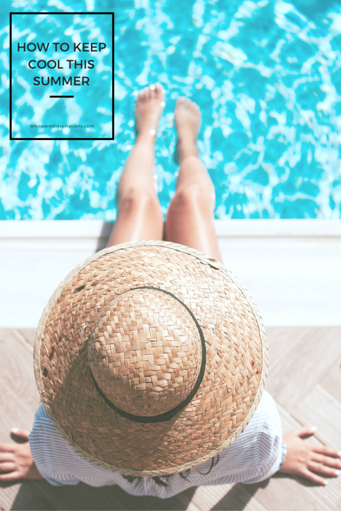 A woman sits by the edge of a pool. It's a top view of her, only her hat, and legs dipped in the pool are seen. A banner reads, "How to Keep Cool this Summer."