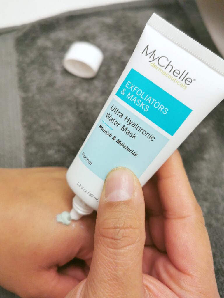 The MyChelle Ultra Hyaluronic Water Mask being squeezed out onto Nancy's hand.