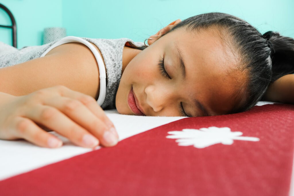 Mimi closes her eyes and tries out her new Juno mattress.