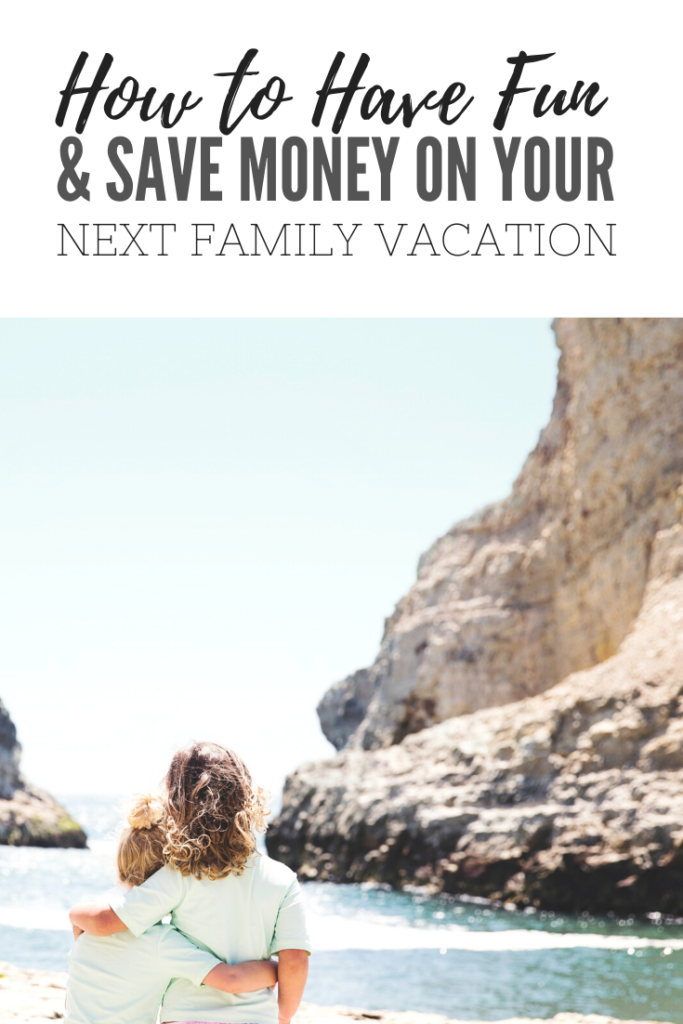 Only the backs of two young sisters are seen as they embrace. Together, they watch the waves of a beautiful seascape. A banner reads, "How to have fun and save money on your next vacation."