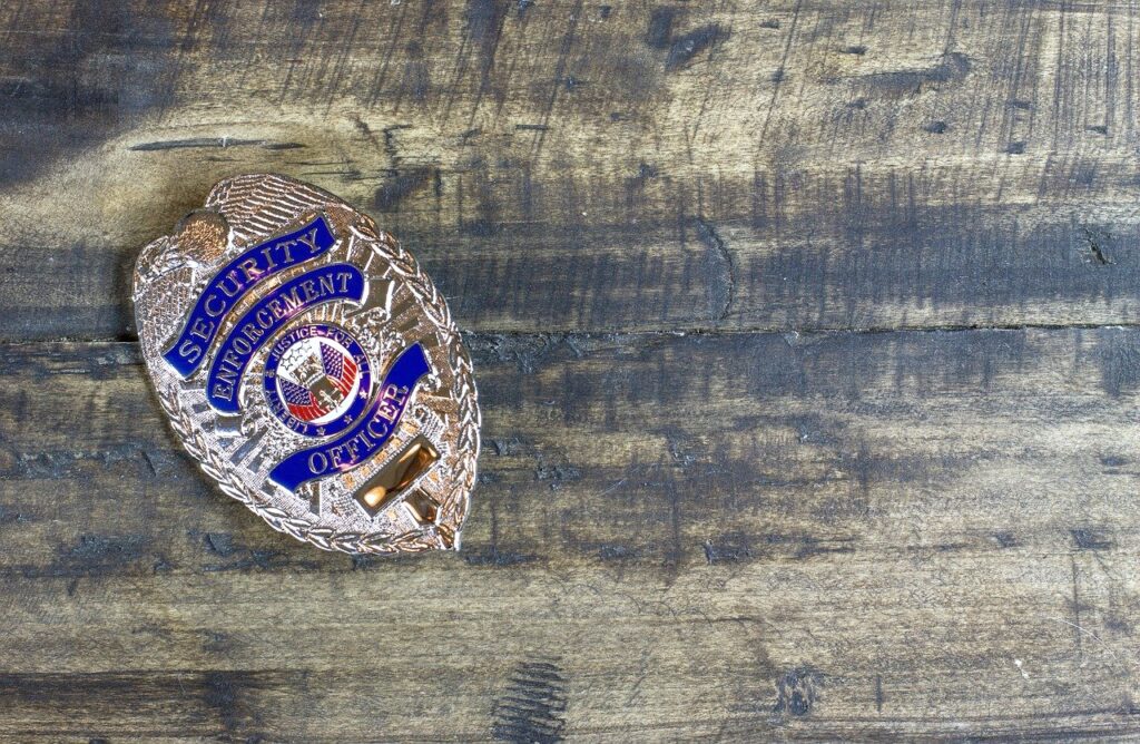 A wooden table with a Security Officer badge on top. 
