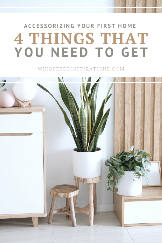 A living room with beautiful plants against a white wall. A banner reads, "Accessorizing Your First Home, 4 Things You Need to Get."