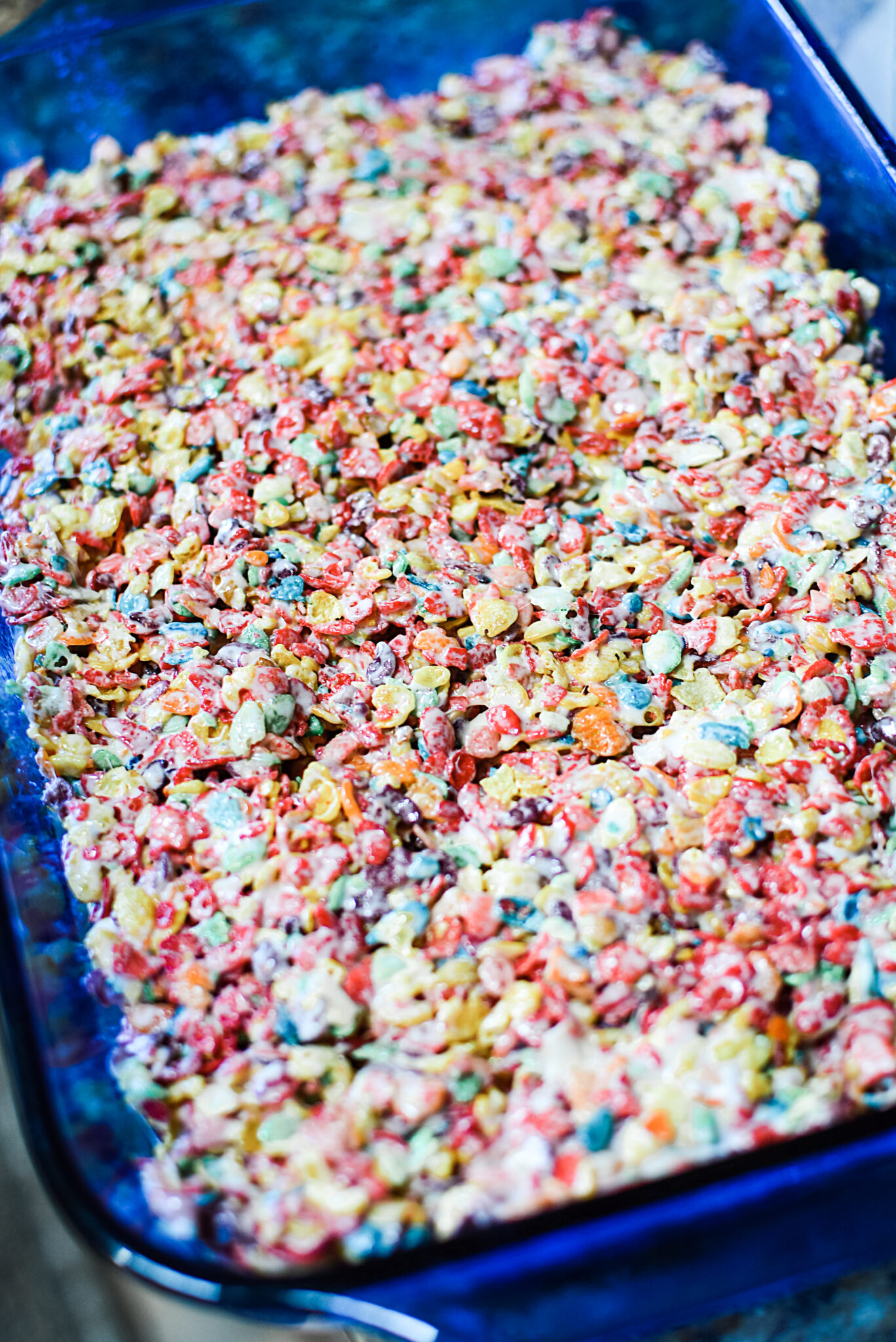 The Fruity Pebbles cereal and marshamallow mix pressed into a greased pan.