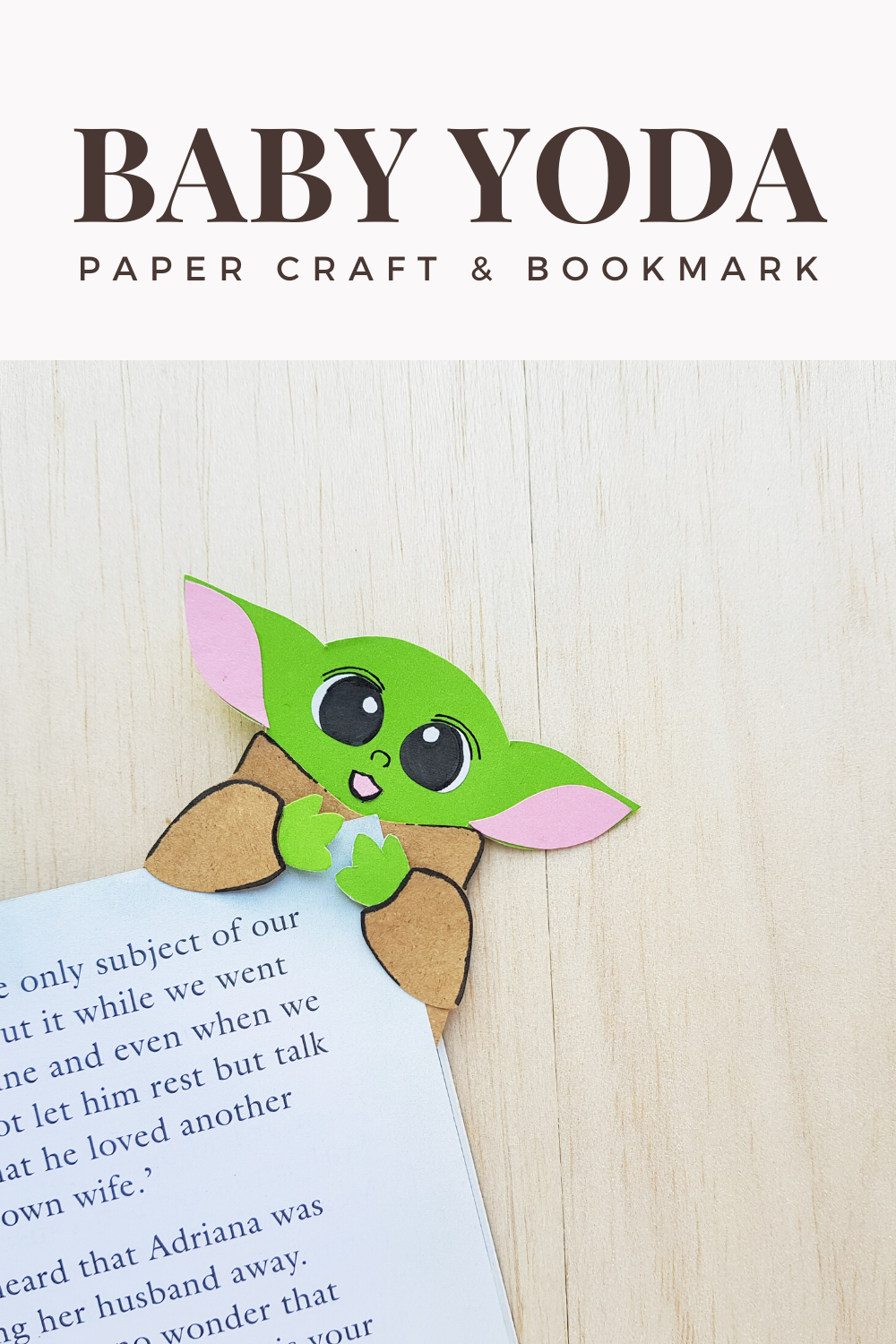 A banner reads, "Baby Yoda Paper Craft & Bookmark," a picture of the finished Baby Yoda paper craft and bookmark on a corner of a book.