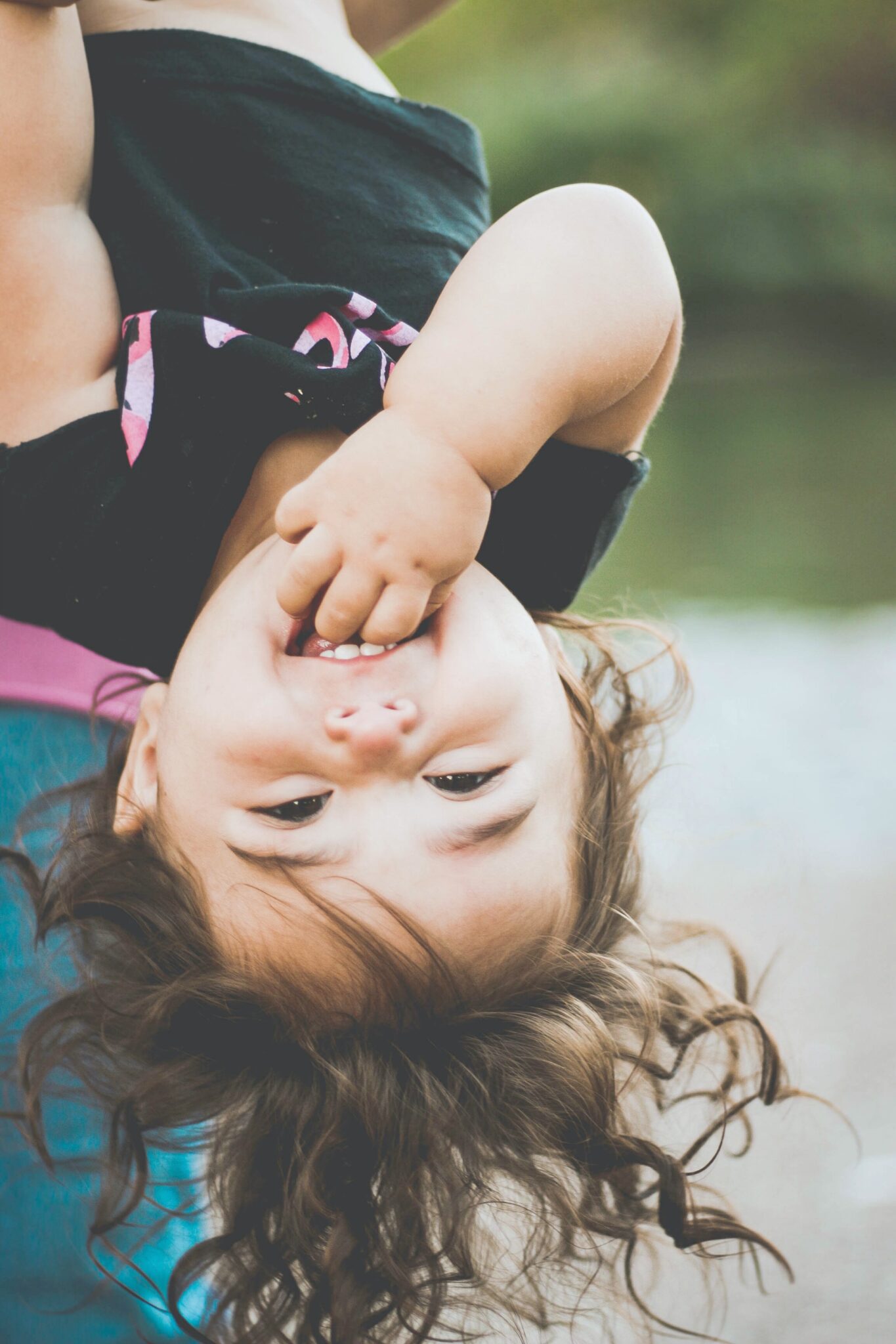 A child is hanging upside down.