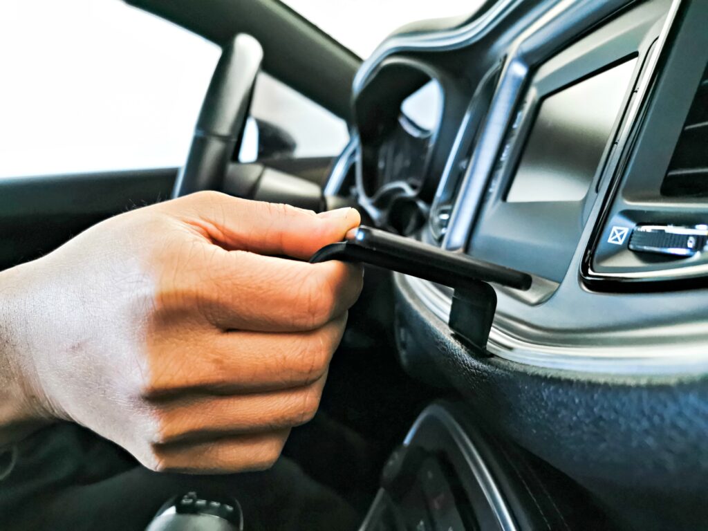 Darasak shows the ProClip mount being inserted into the seam between the dashboard and silver lining. 