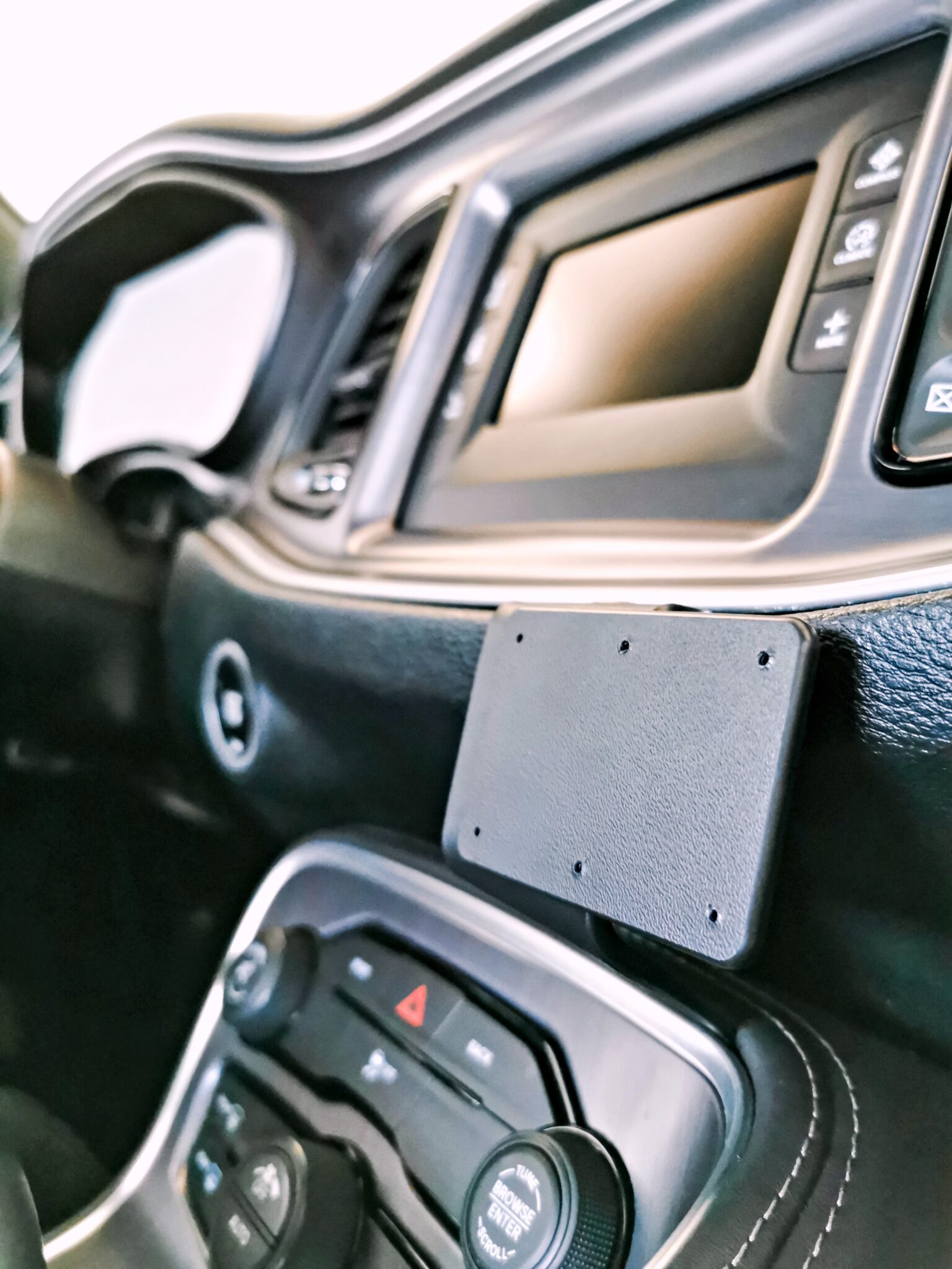 The dashboard of the Dodge Challenger underneath the media screen with ProClip mount installed.