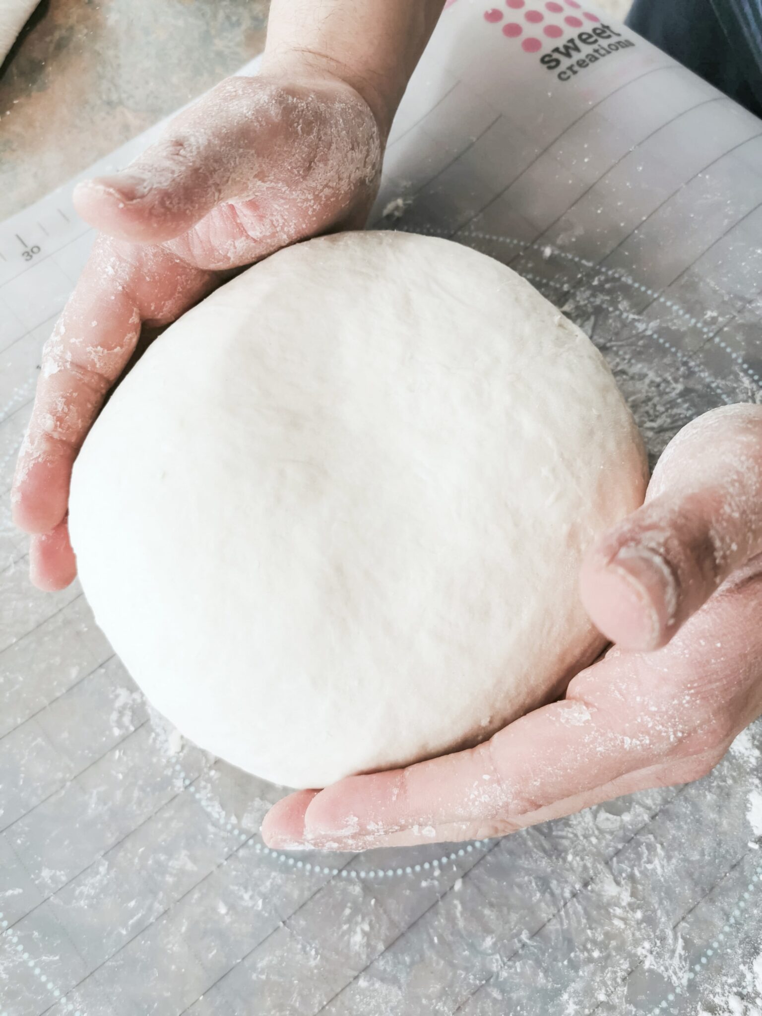 A man holds the dough to bake loaves of bread.