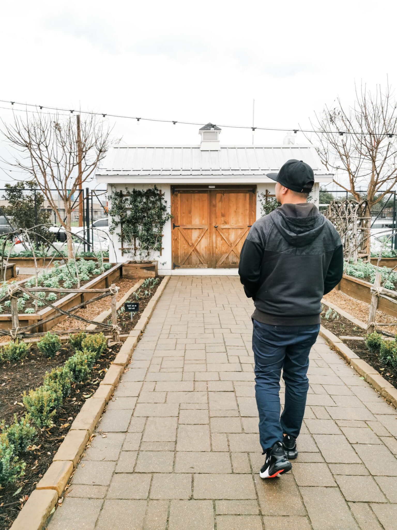 Darasak walks through the Magnolia Seed + Supply garden at Magnolia Market. 