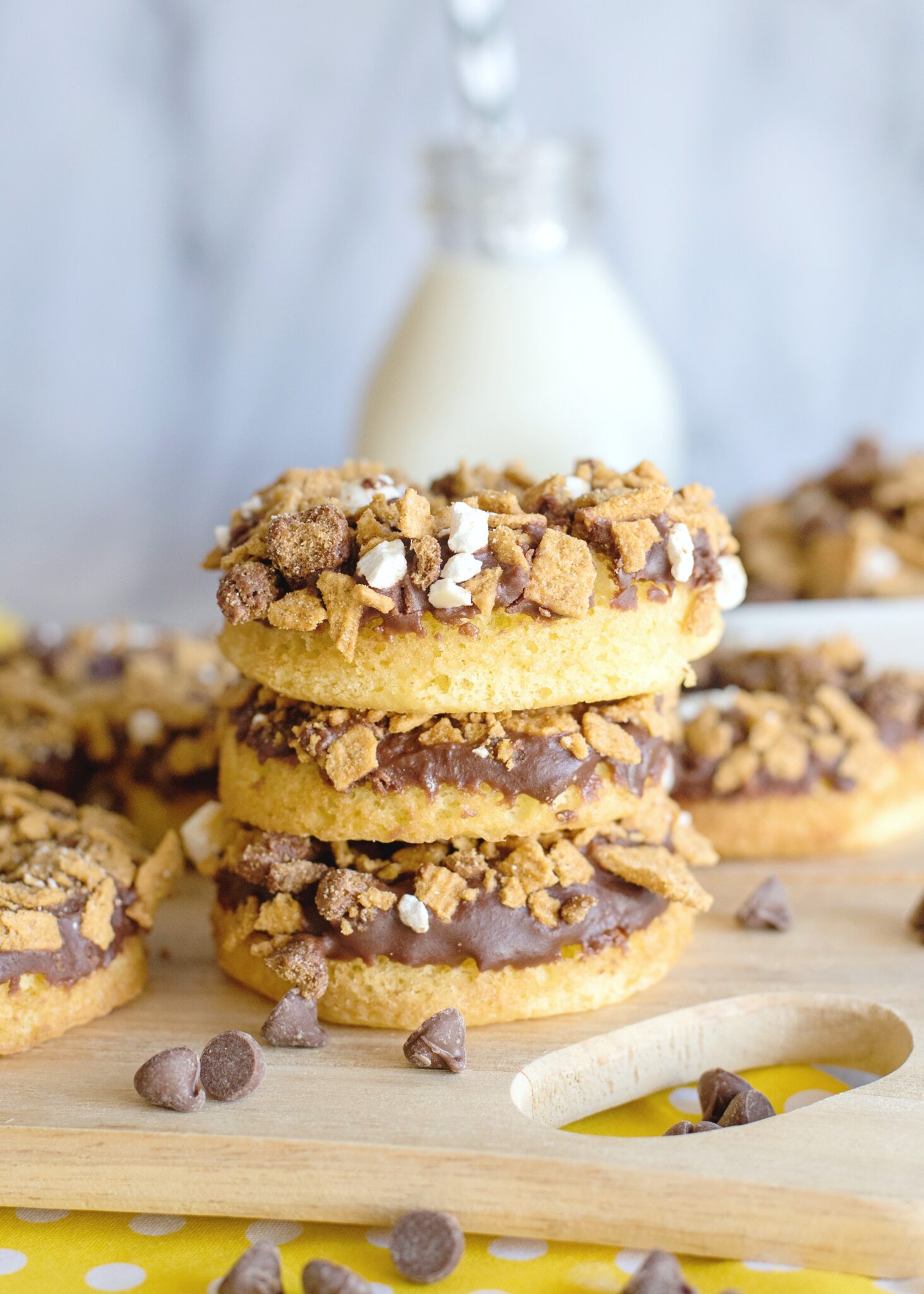 S'mores donuts are stacked with a can of milk with a straw in the background. 