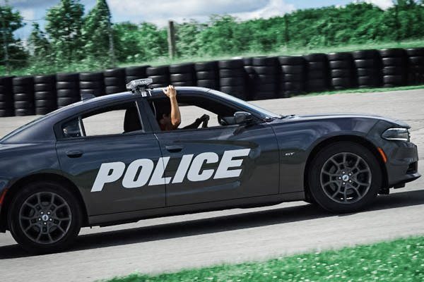 A police car being chased in a closed course. 