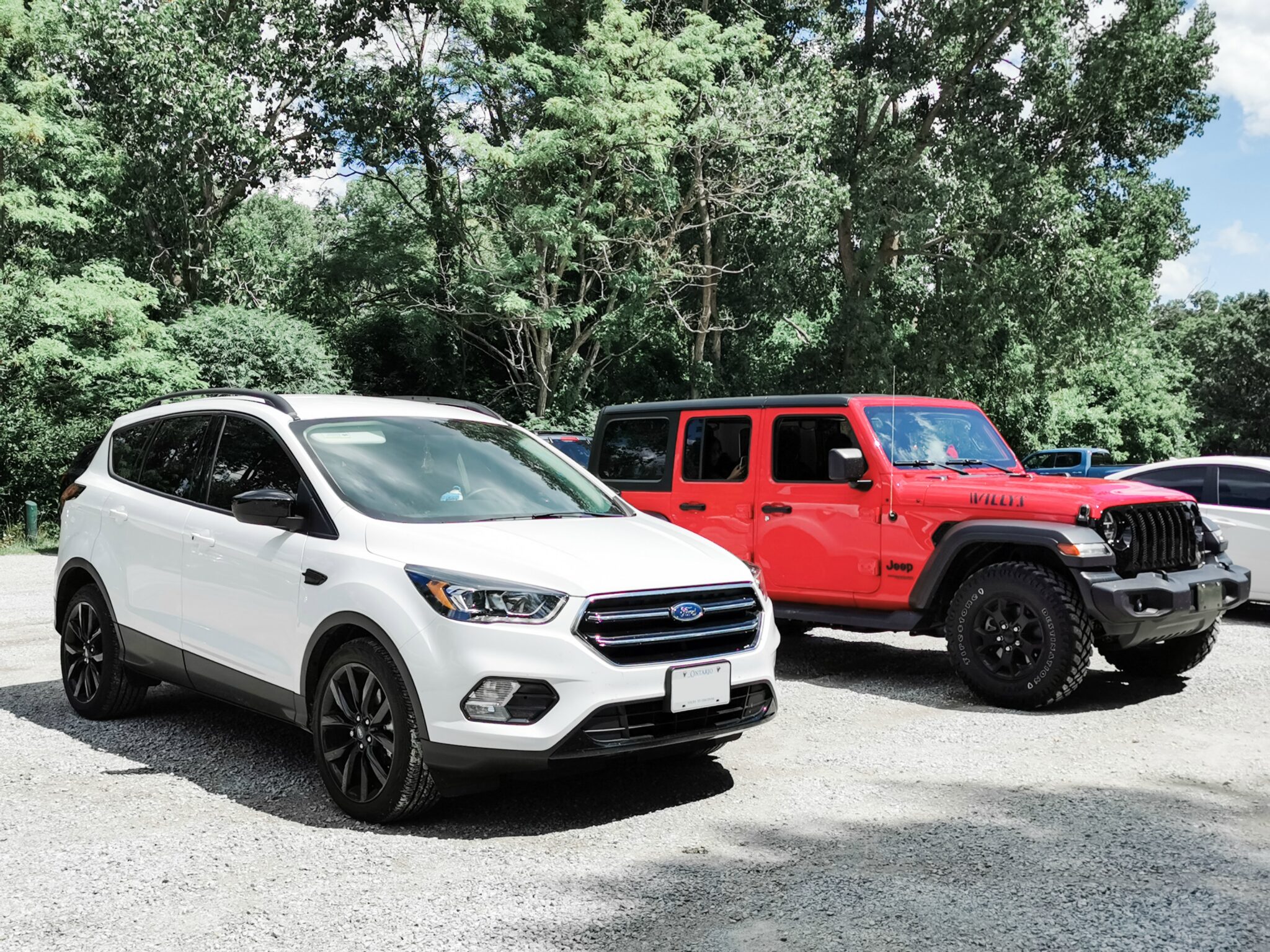 A Ford Escape and a Jeep Wrangler parked at one of Sarnia's beaches.  The jeep is equipped with ProClip USA Jeep accessories.