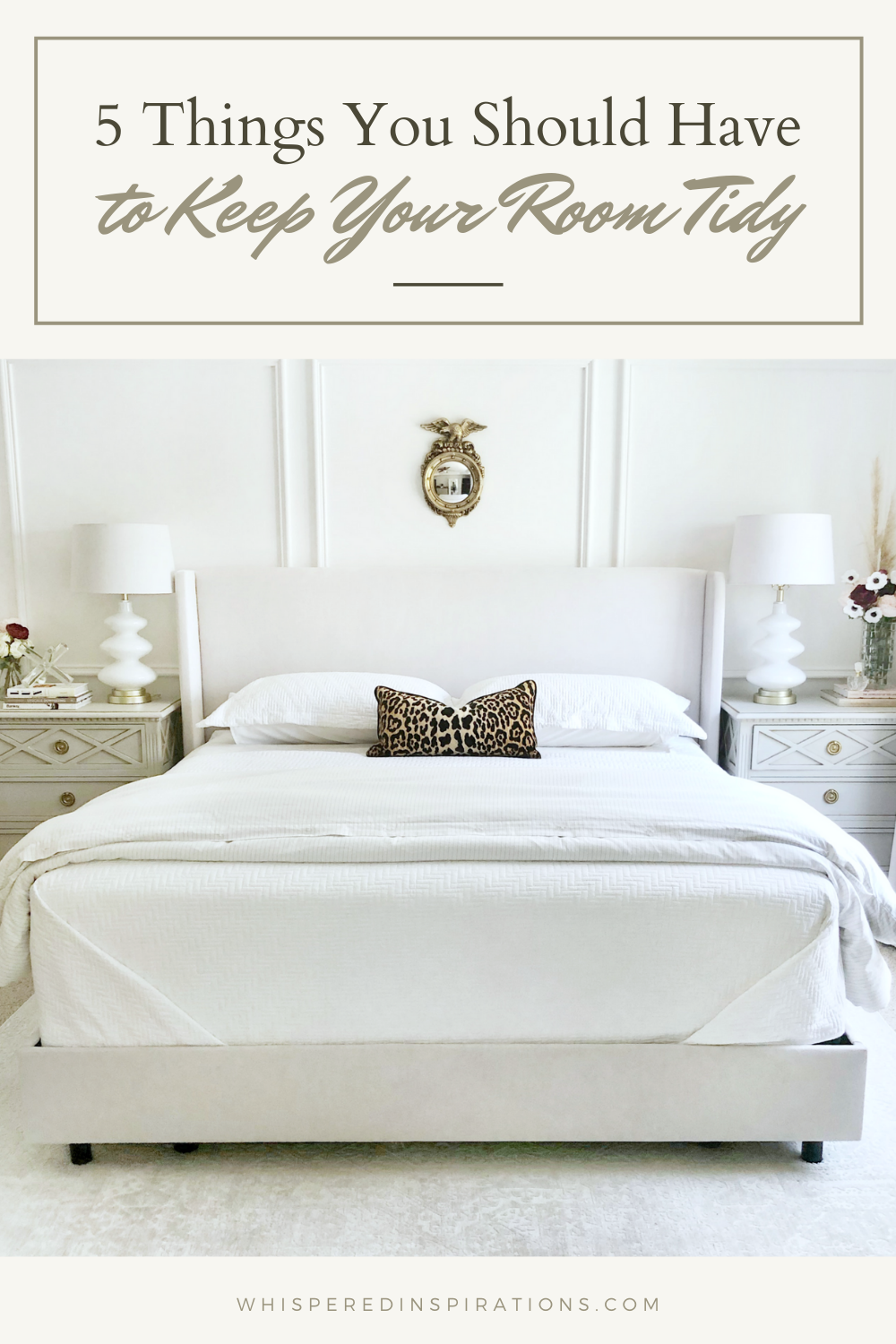 A beautiful, clean, white bedroom, that is tidy. It has a small mirror above the bed. The bedroom is to signify and share the 5 things you should have in your room to keep it tidy.