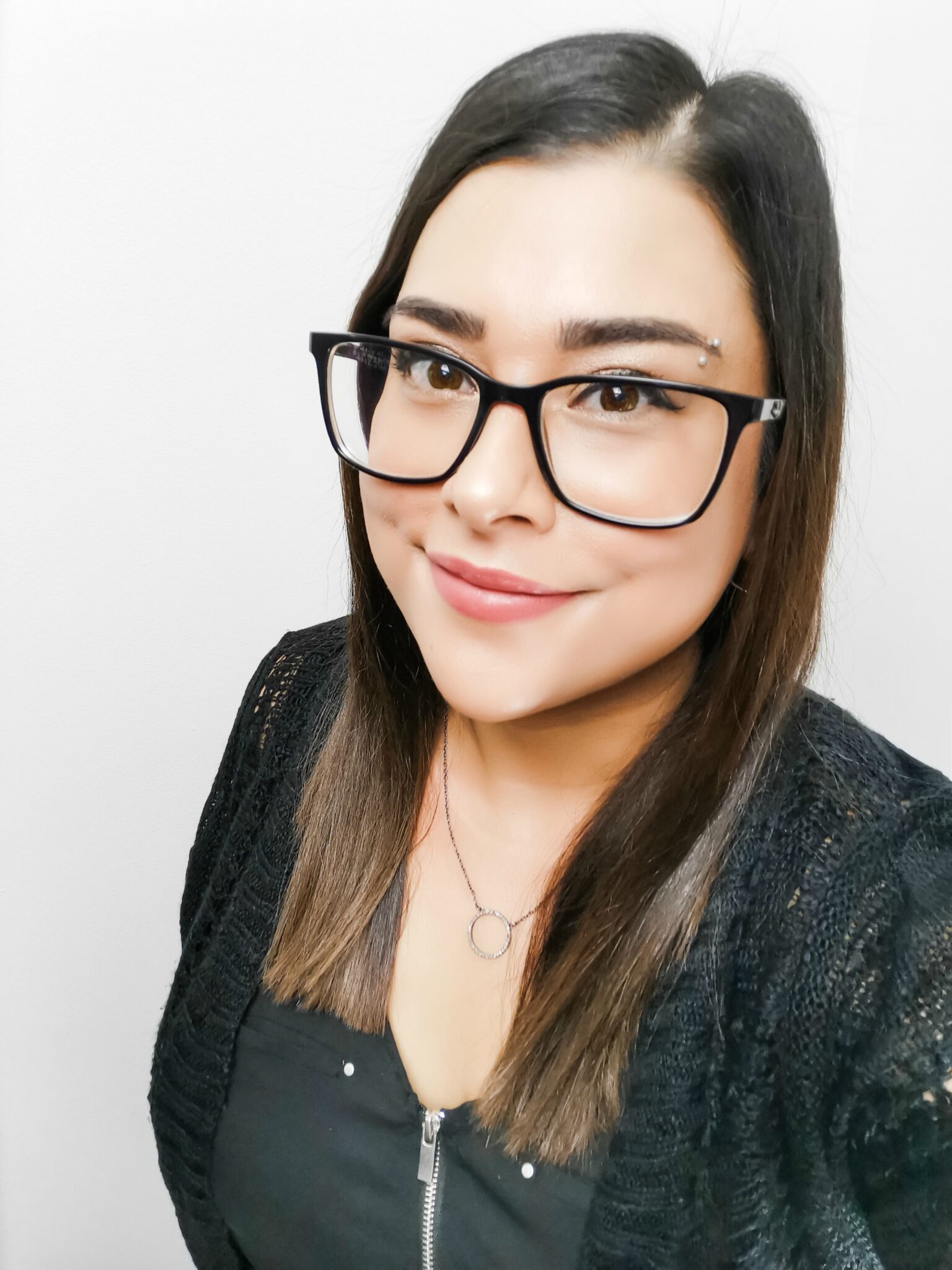 Nancy smiling at the camera against a white background.