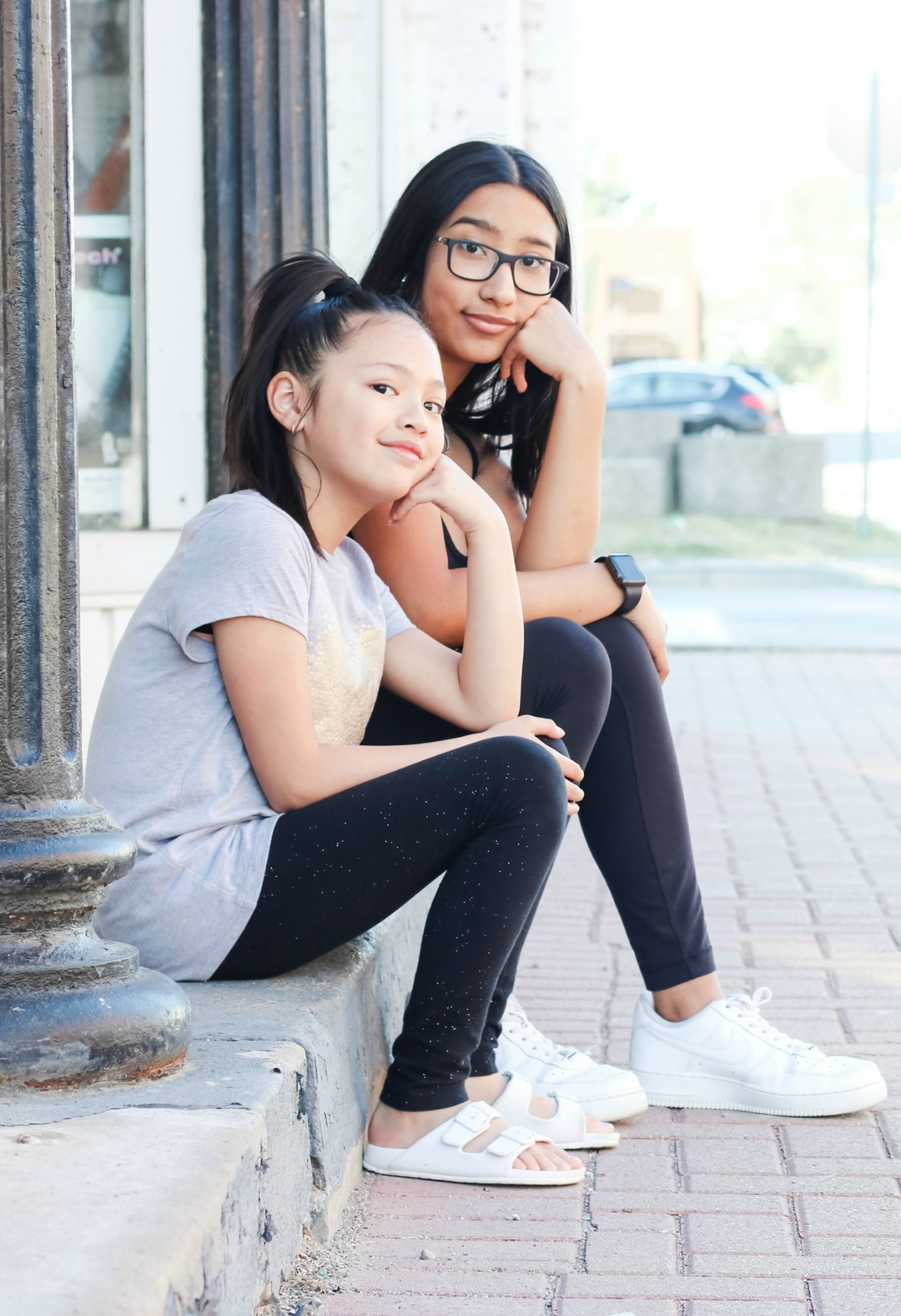 Mimi and Gabby sitting on a step in Amherstburg.