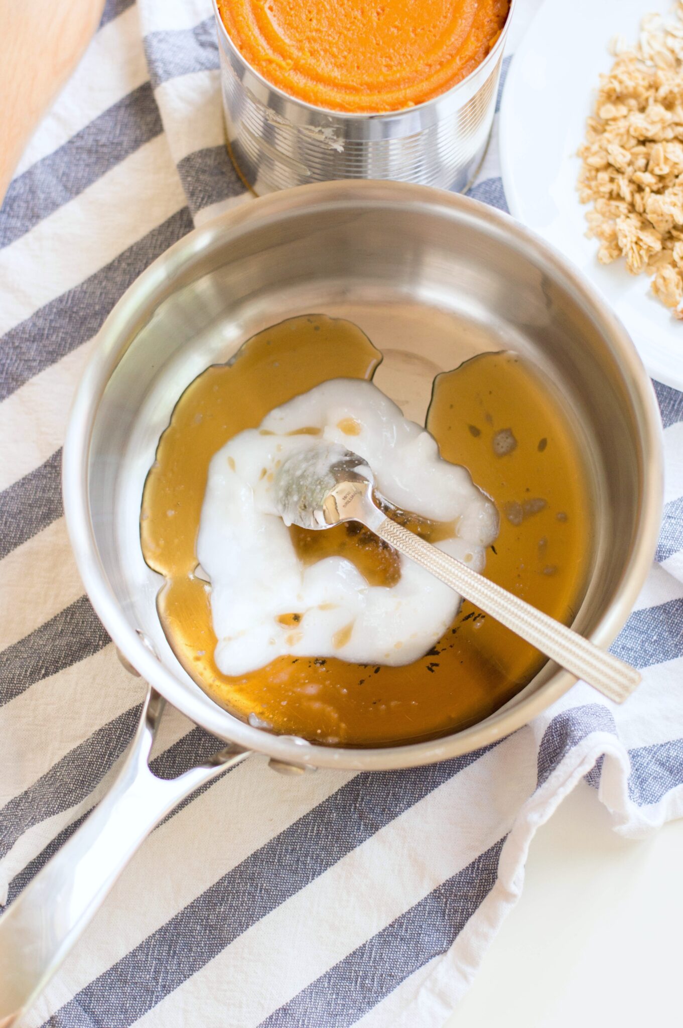 Medium saucepan with wet ingredients for Pumpkin Maple Pecan granola.