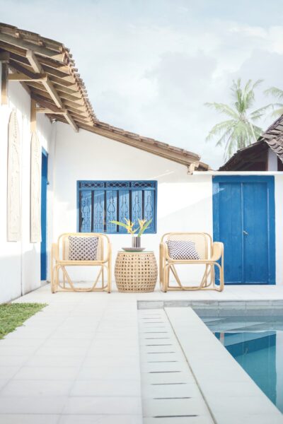A beautiful patio area in front of a pool. One of the ways on how to create the perfect outdoor space in your home.