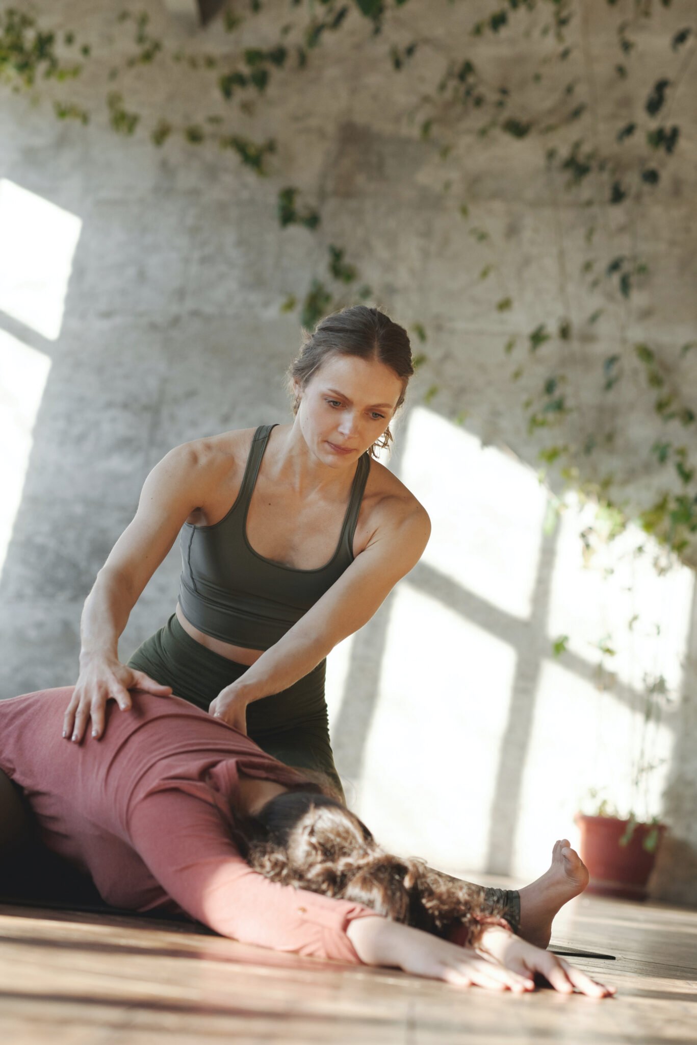 A personal trainer helps a woman stretch and work out for her wedding. 