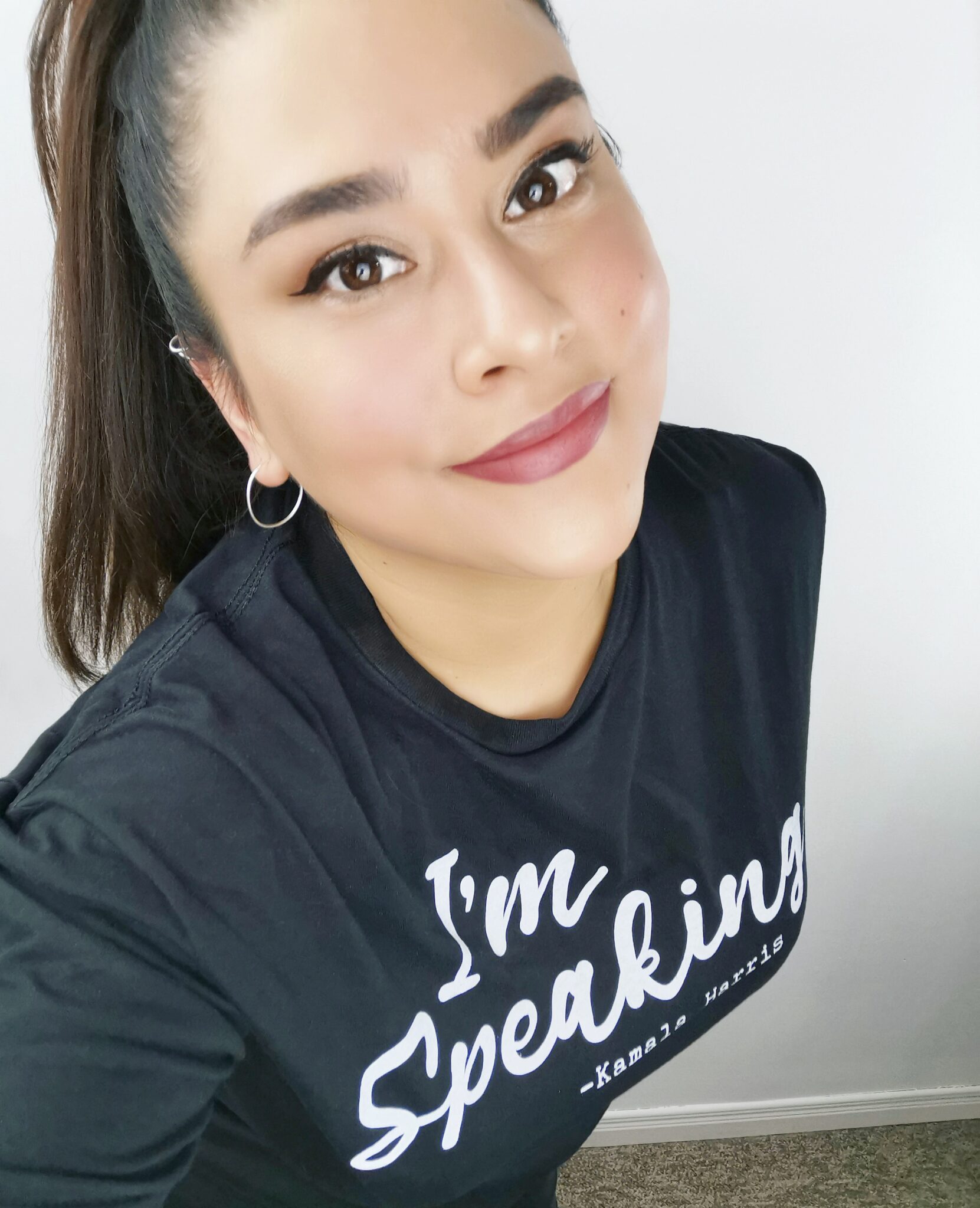 Nancy smiling while wearing an, "I'm Speaking," t-shirt.