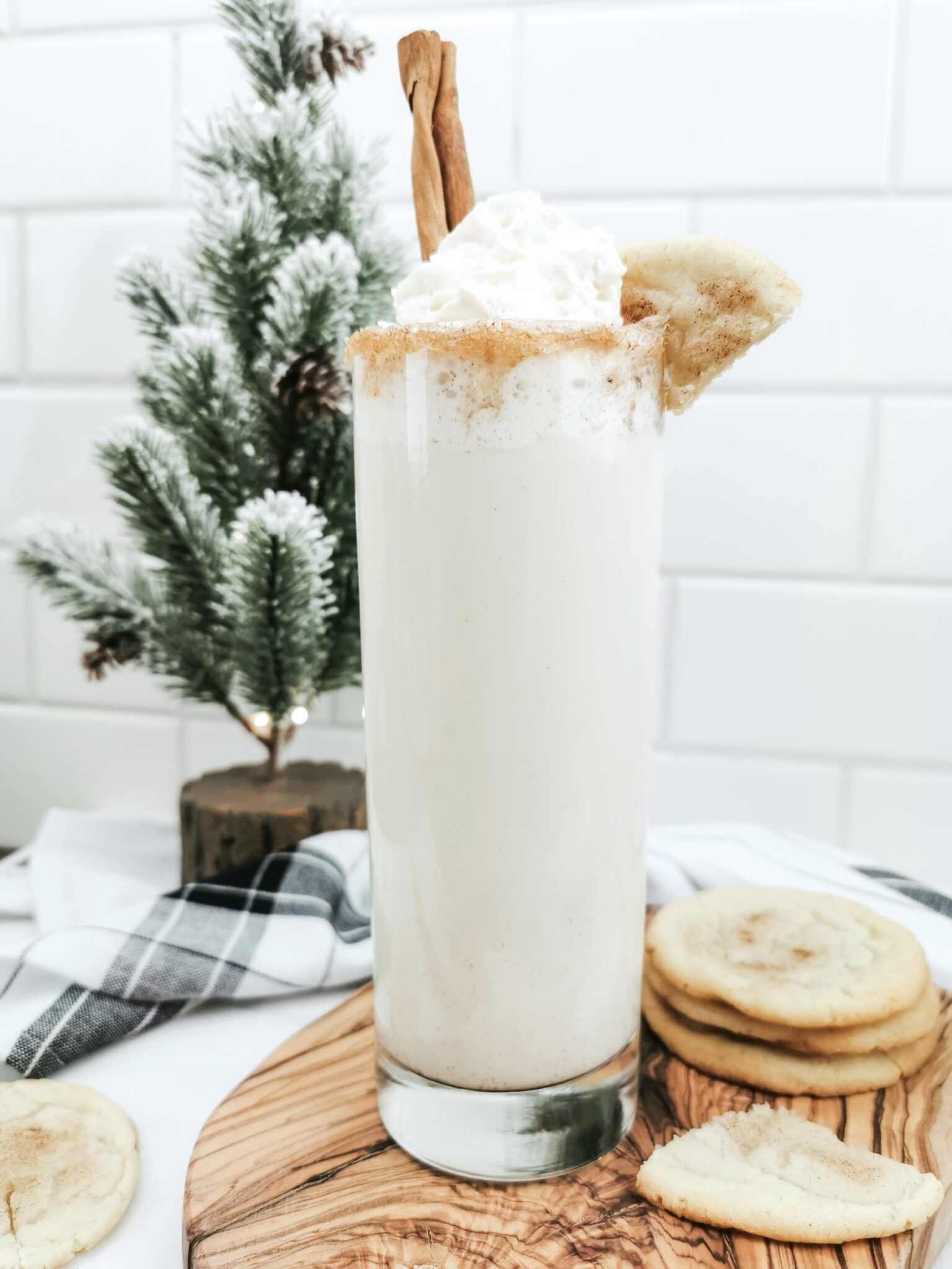 A tall glass filled with caramel protein shake, mixed with cinnamon and Torani sugar-free syrup. It is the festive Caramel Snickerdoodle Mocktail.