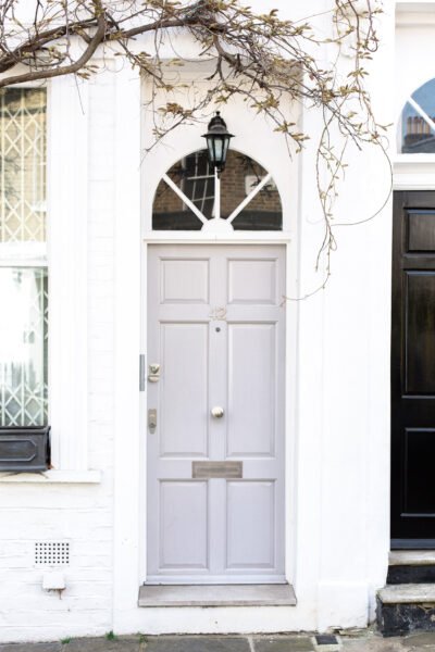 A white building with a grey door. Above the grey door there is an angled window. This article covers tips for when you're ready to sell your property.