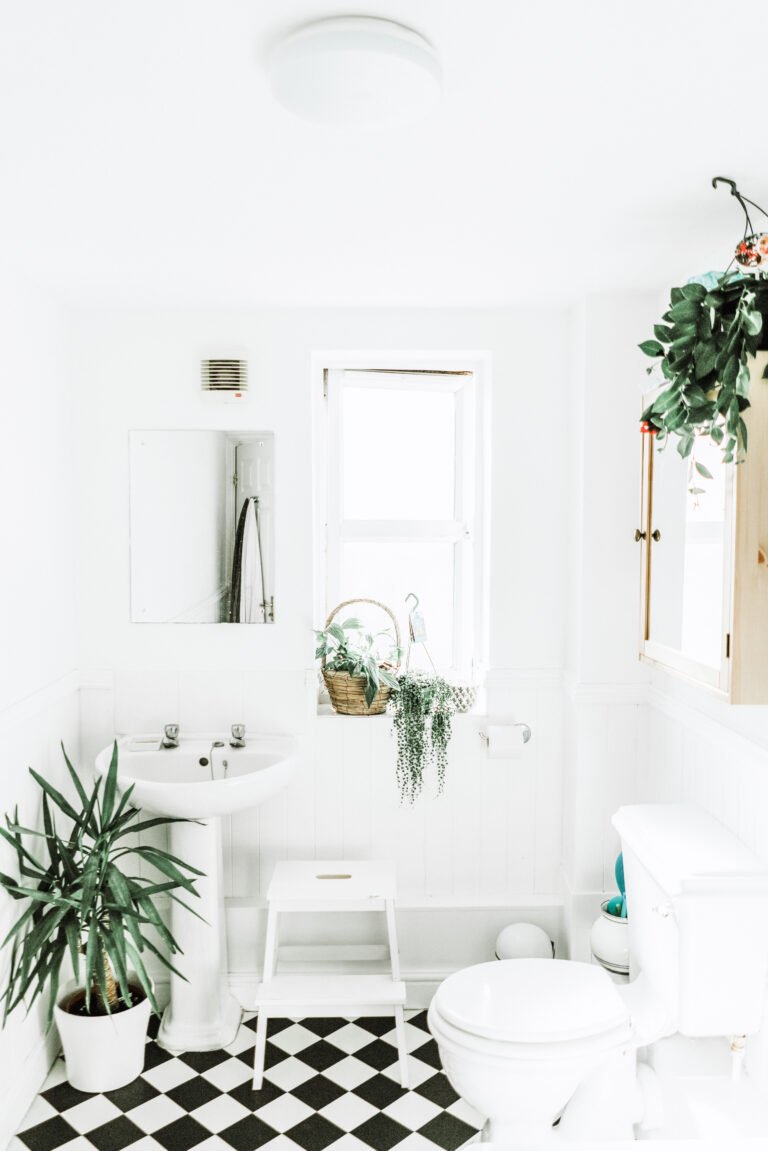 A black and white bathroom in need of some upgrades. This article covers 4 simple ways to upgrade your bathroom.