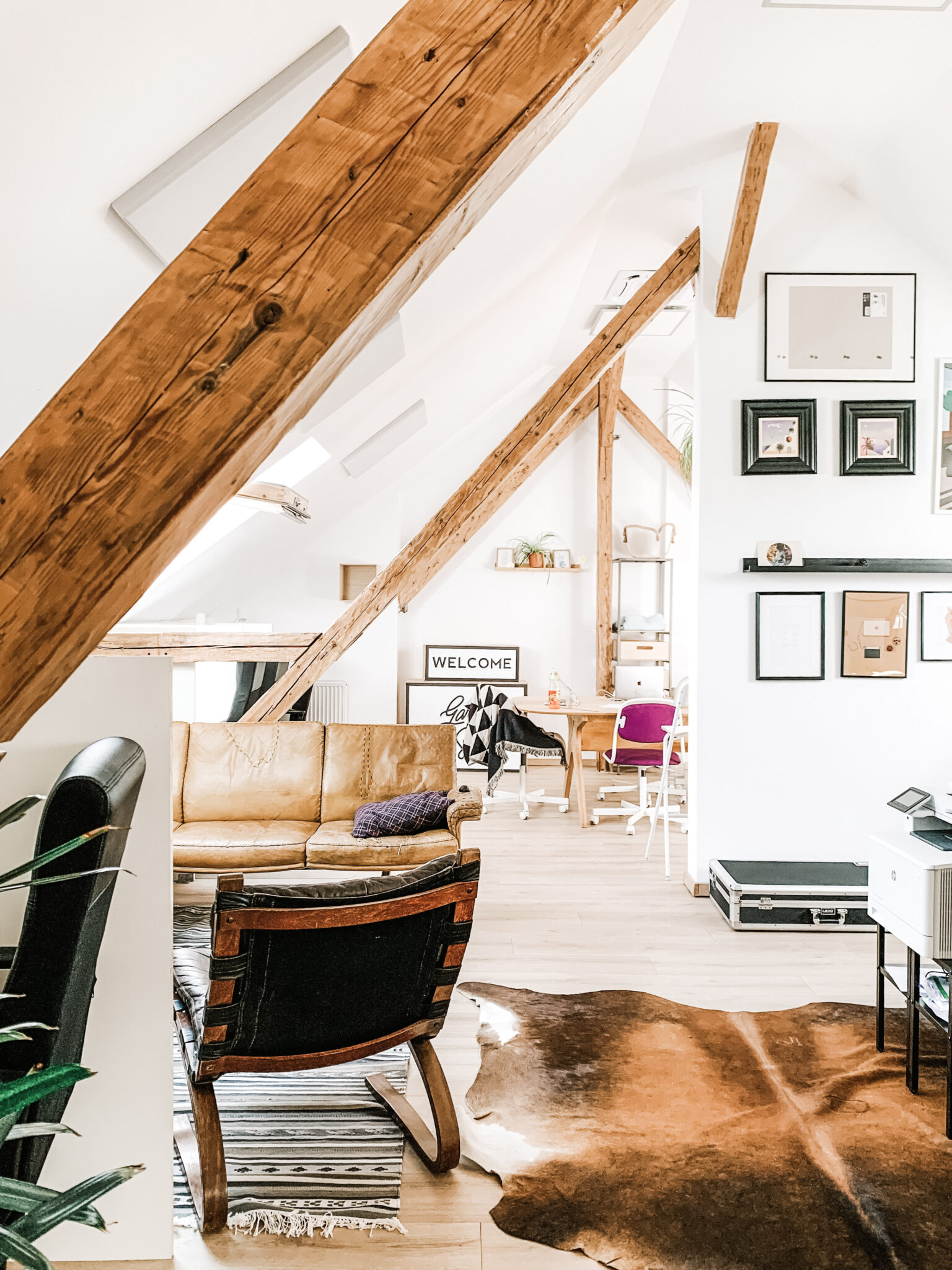 A beautiful, fully functional living space in the attic. It's filled with light and furniture. This article answers the question, "should you get an attic conversion?"